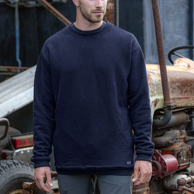 Male worker wearing The Crew Sweatshirt by 1620 Workwear in Uniform Blue