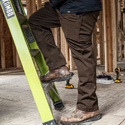 Men's Shop Pant being worn during construction work with a ladder