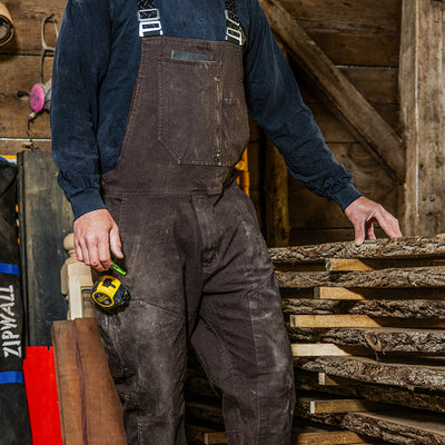 Wood worker wearing The Overall by 1620 Workwear in Dermitasse Brown